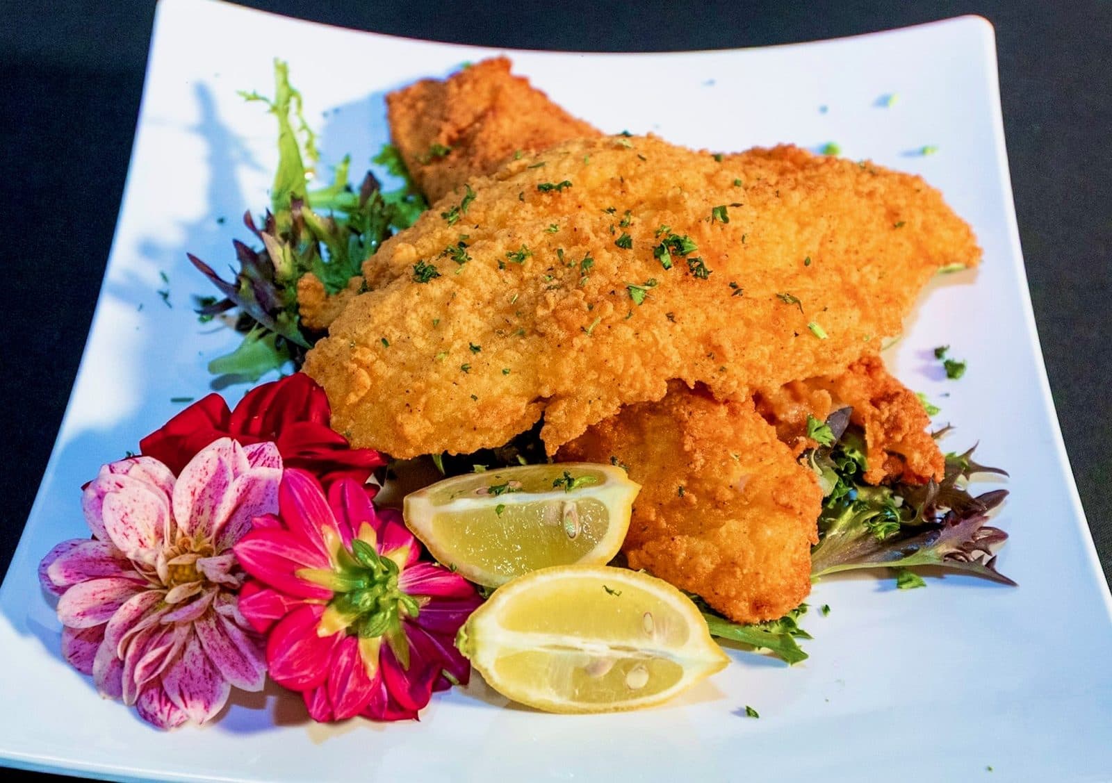 Golden fried plate with lemon and fresh greens