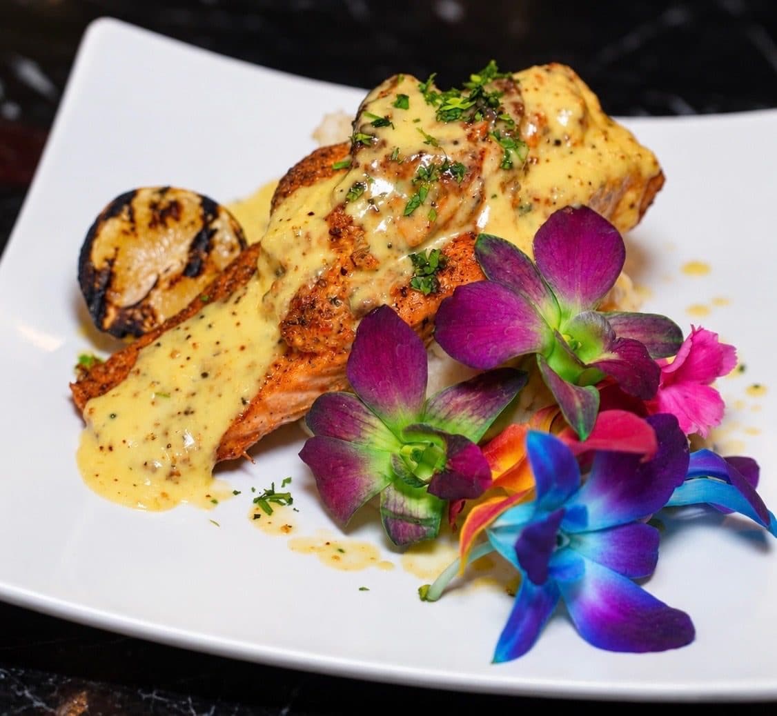 Seafood entree in cream sauce with grilled lemon