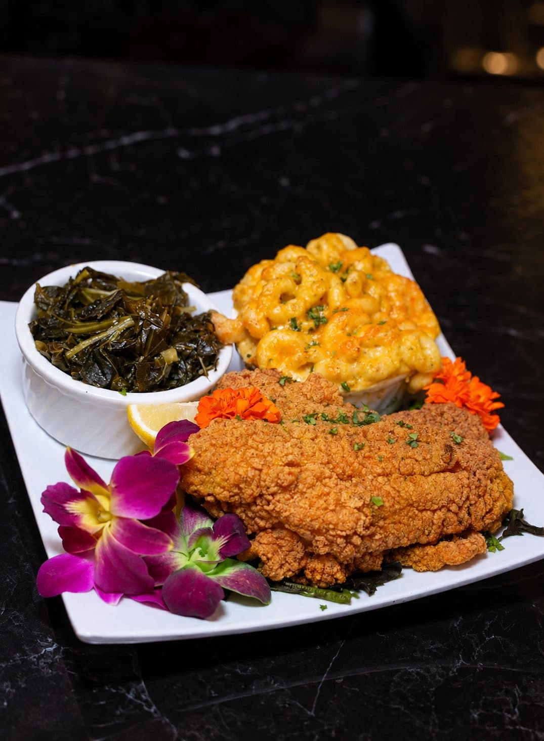 Soul food plate with collard greens and mac and cheese at Pizookah Lounge