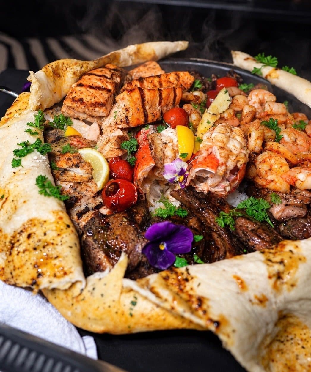 Tableside platter with lobster, shrimp, salmon and steak