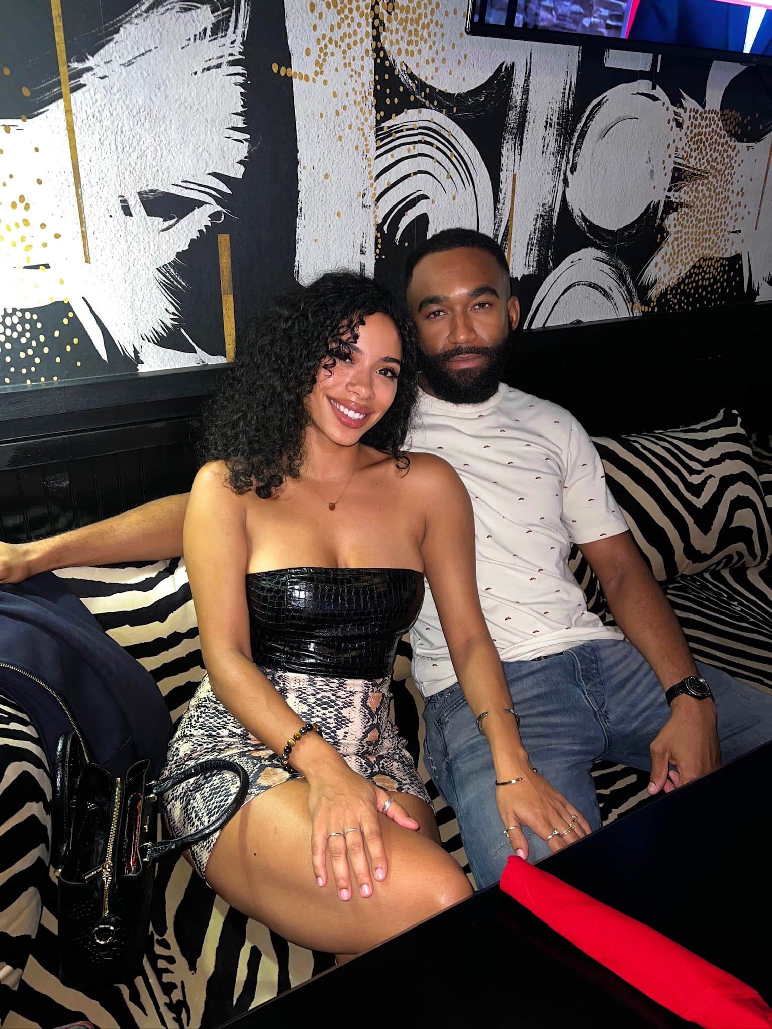 Couple on a zebra-print banquette at Pizookah Lounge — date night spot in Kennesaw, GA